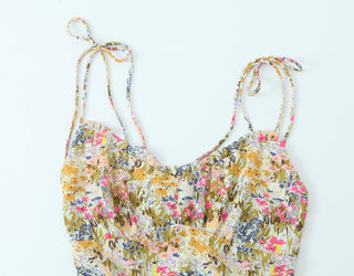 Floral patterned top with thin straps on a white background