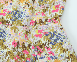 Floral patterned fabric with pink, blue, and brown colors on a white background